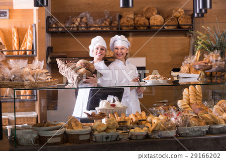 Bakery staff offering bread 29166202