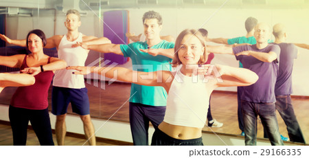 Smiling people learning zumba steps Smiling people learning zumba steps 29166335