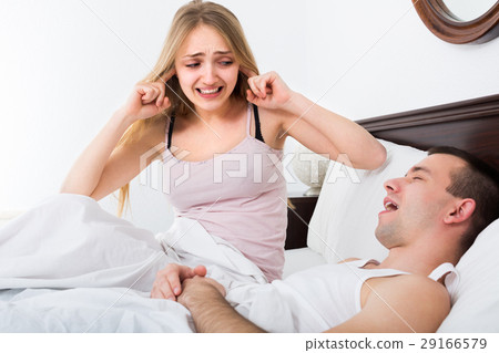 Woman disturbed with partner snores. 29166579