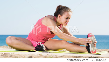 Happy young sportwoman training gymnastics 29166584
