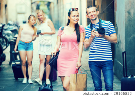 Young cheerful family tourists photographing in city Young cheerful family tourists photographing in city 29166833