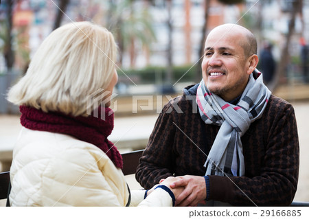 Mature couple chatting in street Mature couple chatting in street 29166885