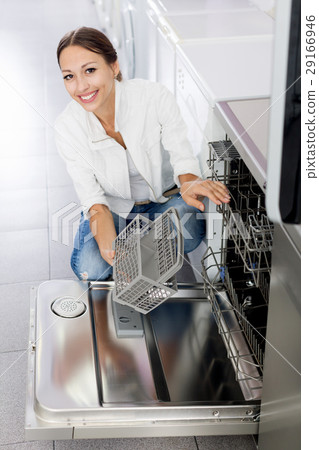 Woman selecting modern dishwasher Woman selecting modern dishwasher 29166946