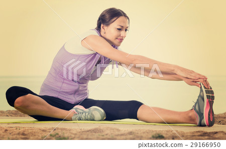 Active woman training on sea beach on sunny morning Active woman training on sea beach on sunny morning 29166950