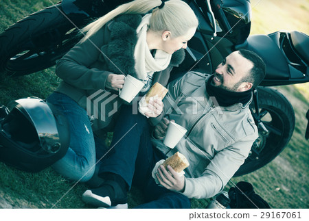 young adults near motorcycle 29167061