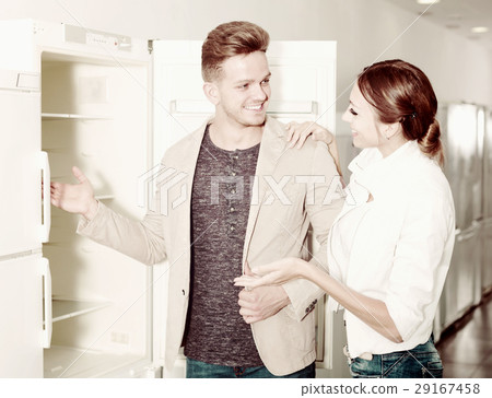 Ordinary young customers looking at fridges 29167458