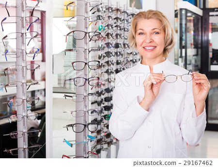Optician standing near spectacles Optician standing near spectacles 29167462