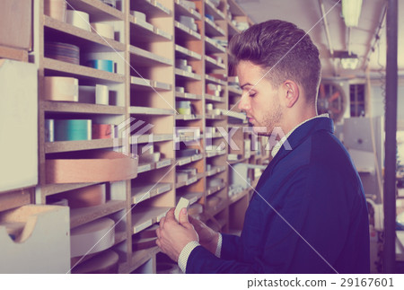 Young smiling guy searching for items in storage Young smiling guy searching for items in storage 29167601