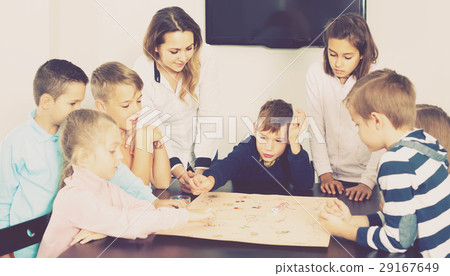 Children making move on pre-marked surface of board game Children making move on pre-marked surface of board game 29167649