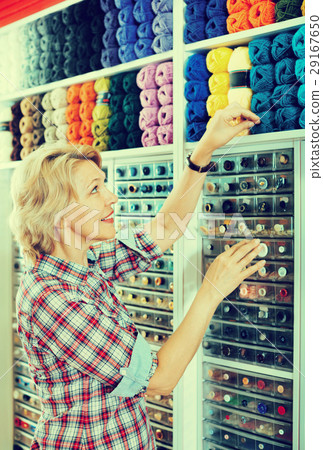 Mature glad woman customer picking various yarn Mature glad woman customer picking various yarn 29167650