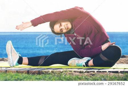 Young woman doing youga at beach 29167652