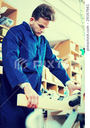 Man processing plank at workshop Man processing plank at workshop 29167661
