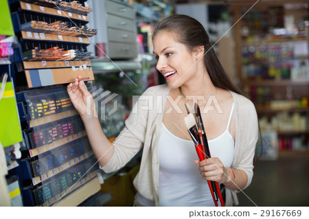 Portrait of cheerful woman choosing brushes for drawing Portrait of cheerful woman choosing brushes for drawing 29167669