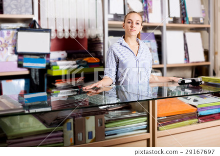 Woman seller looking helpful at counter 29167697