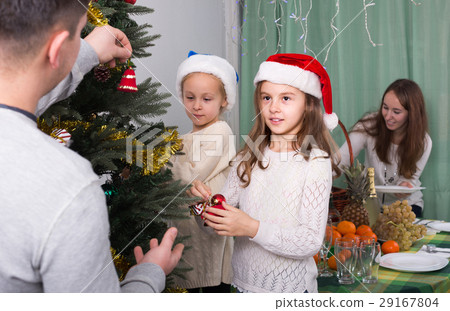 Family decorating Christmas tree at home. 29167804