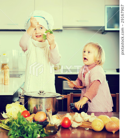 Two little sisters at home kitchen Two little sisters at home kitchen 29167907