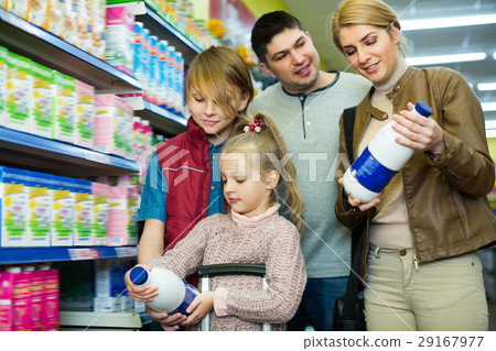 Happy family of four buying pasteurized milk Happy family of four buying pasteurized milk 29167977