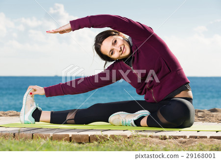 girl exercising on exercise mat outdoor 29168001