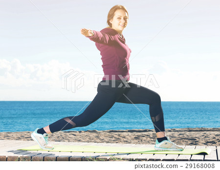 girl exercising on exercise mat outdoor 29168008