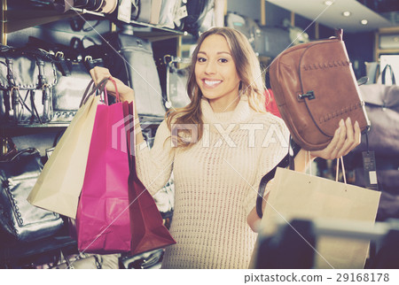 Young woman customer purchasing new hand bag Young woman customer purchasing new hand bag 29168178