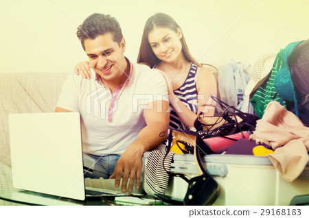 Couple with notebook and credit card. Couple with notebook and credit card. 29168183