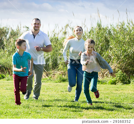 Family happily playing and running 29168352