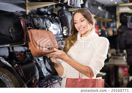 Female choosing bag among assortment 29168771