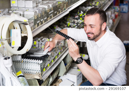 Man picking plastic dowel 29169107