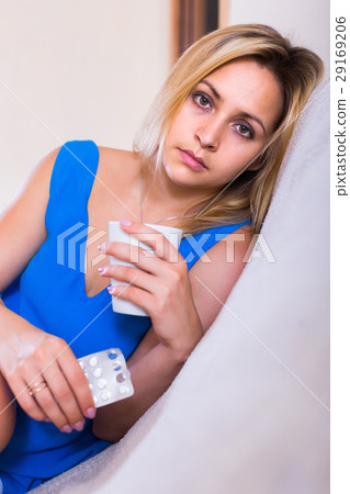 Young woman with pills at home Young woman with pills at home 29169206