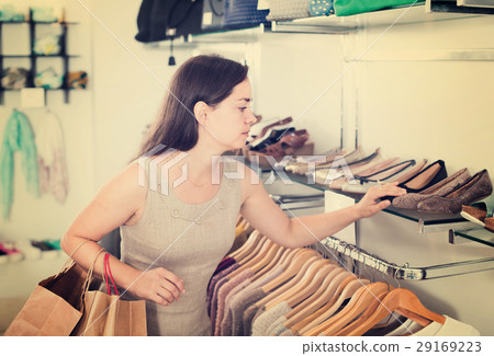 female customer selecting shoes in footgear center 29169223
