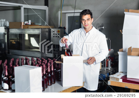 Man standing in packing section on winemaking factory 29169295