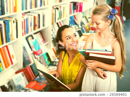 Woman showing open book to little girl 29169401