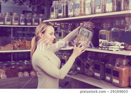 Woman selecting dried herbs Woman selecting dried herbs 29169603