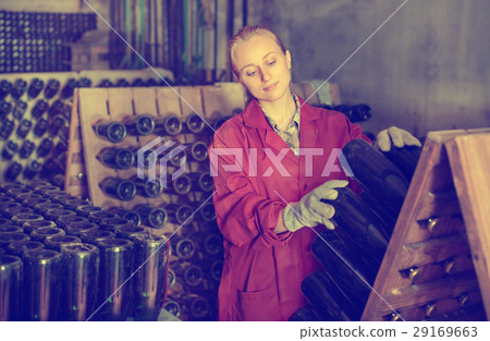 Wine maker taking care of seasoning bottles 29169663