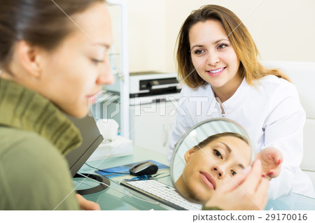 Smiling female client consulting woman doctor Smiling female client consulting woman doctor 29170016