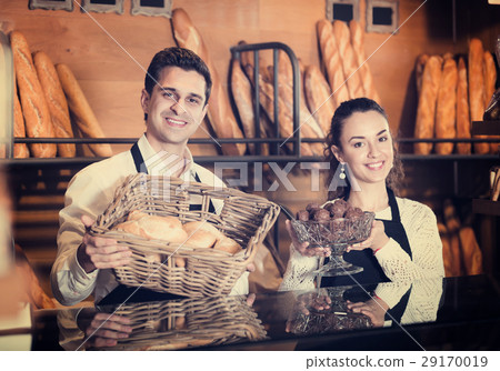 Man and woman bakers in bakery. Man and woman bakers in bakery. 29170019