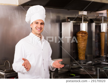 Smiling male chef with meat on grill Smiling male chef with meat on grill 29170020