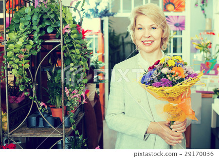 Elderly retiree female customer choosing flowers 29170036
