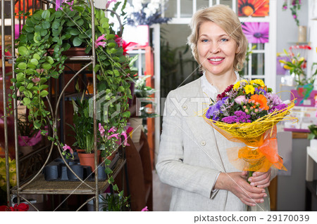 Elderly retiree female customer choosing flowers 29170039