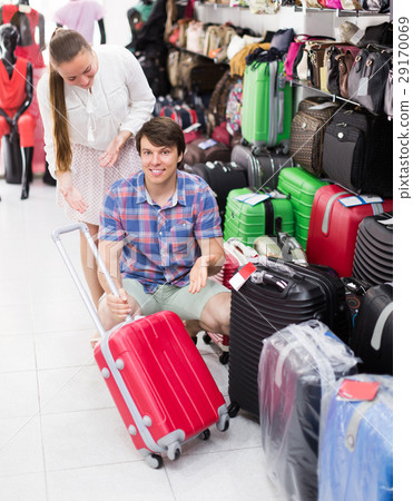 Pair in shop choosing suitcase 29170069