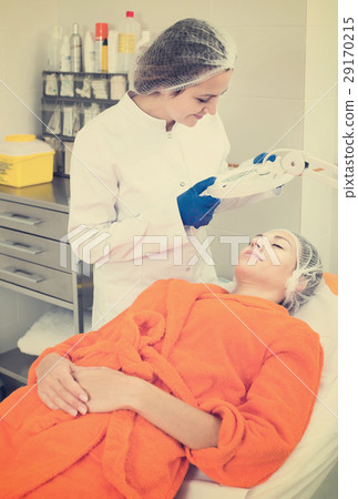 Cosmetologist and female client 29170215