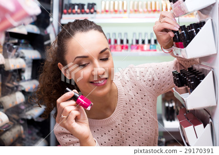 Positive female customer buying nail polish Positive female customer buying nail polish 29170391