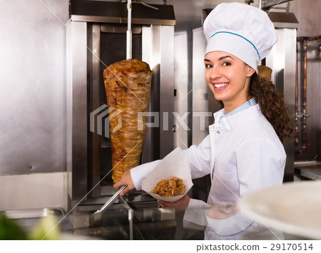 Female chef preparing shawarma . 29170514