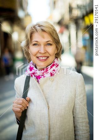 Cheerful retiree woman having a walk in city Cheerful retiree woman having a walk in city 29170541