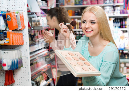Satisfied charming female customer buying skin powder 29170552