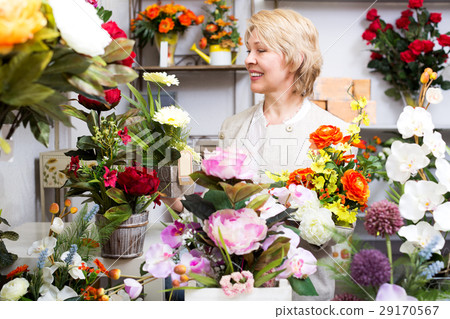 Woman smiling among multicolored flowers 29170567