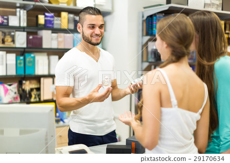 Serving purchaser at cash desk 29170634
