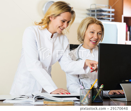 Family doctors therapeutists discussing difficult case in office 29170648