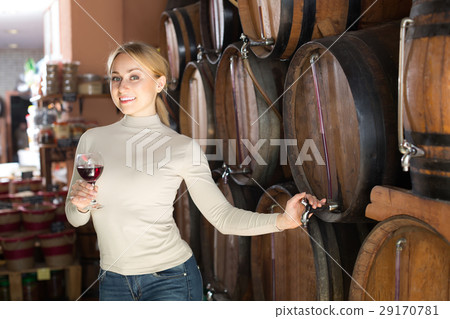 Woman selecting wine in wine house. Woman selecting wine in wine house. 29170781