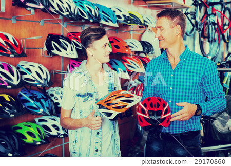 boy with father looking for helmet 29170860